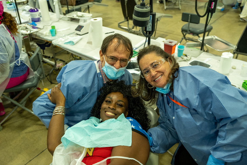 Dental patient smiling with providers